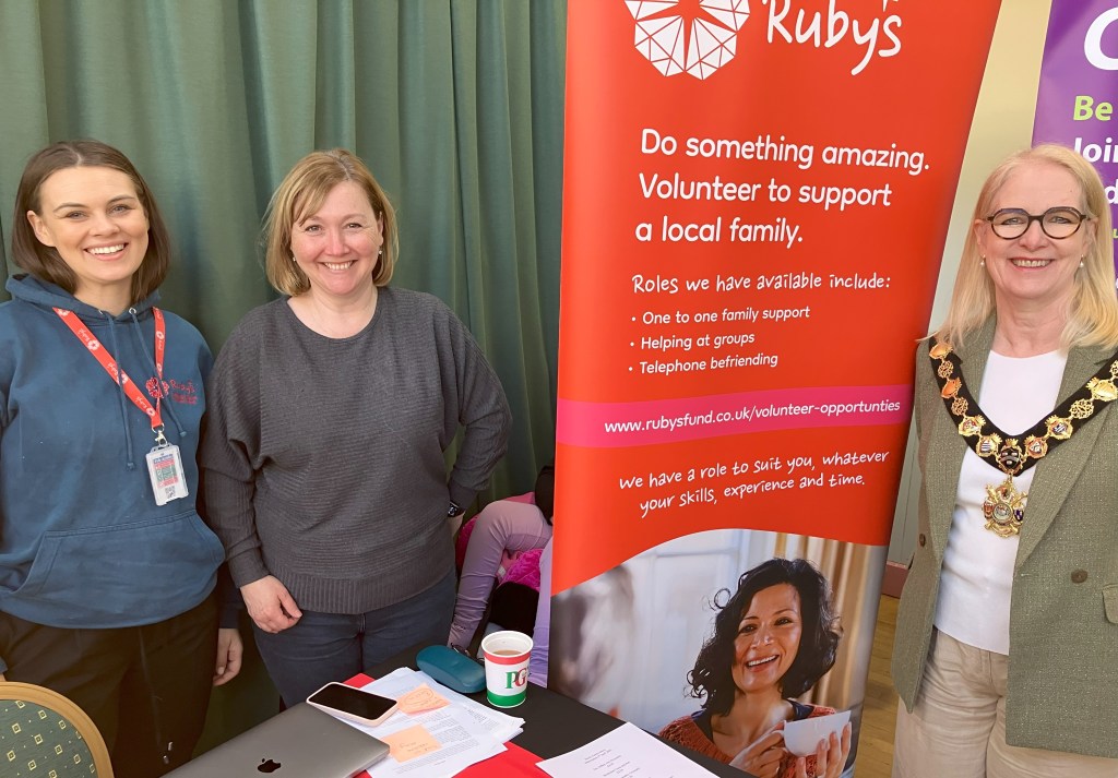 Kay with Ruby's team and banner