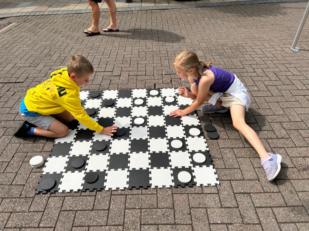Children playing big draughts