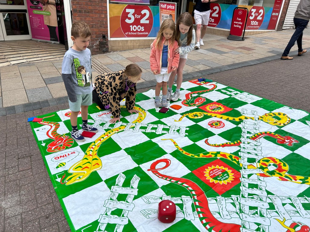 Children playing big snakes and ladders