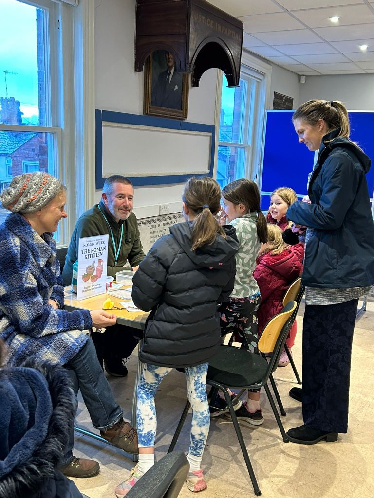 PIctures showing children making coins as part of Roman week.
