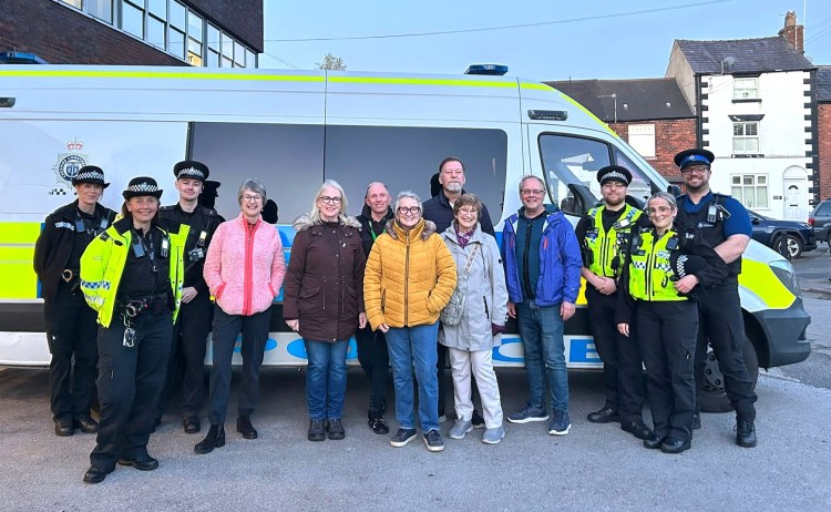 People standing in front of a police van