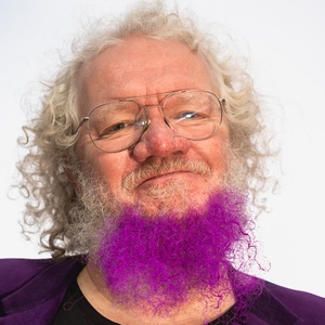 Headshot of David Renton, showing a grey-haired man with glasses and a purple beard.